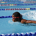 Child swimming confidently after taking our swim classes