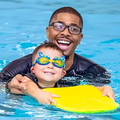 SWIMkids USA instructor teaching a child to swim