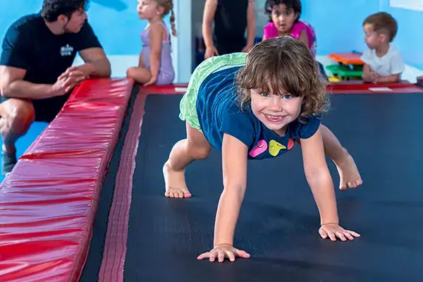 Preschool gym lessons graduate shows her gymnastics techniques