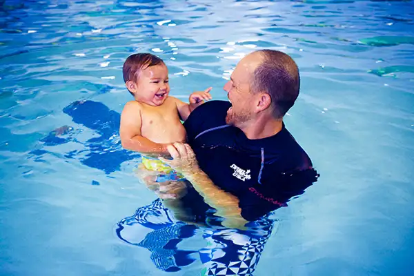 SWIMkids USA instructor teaching student how to swim